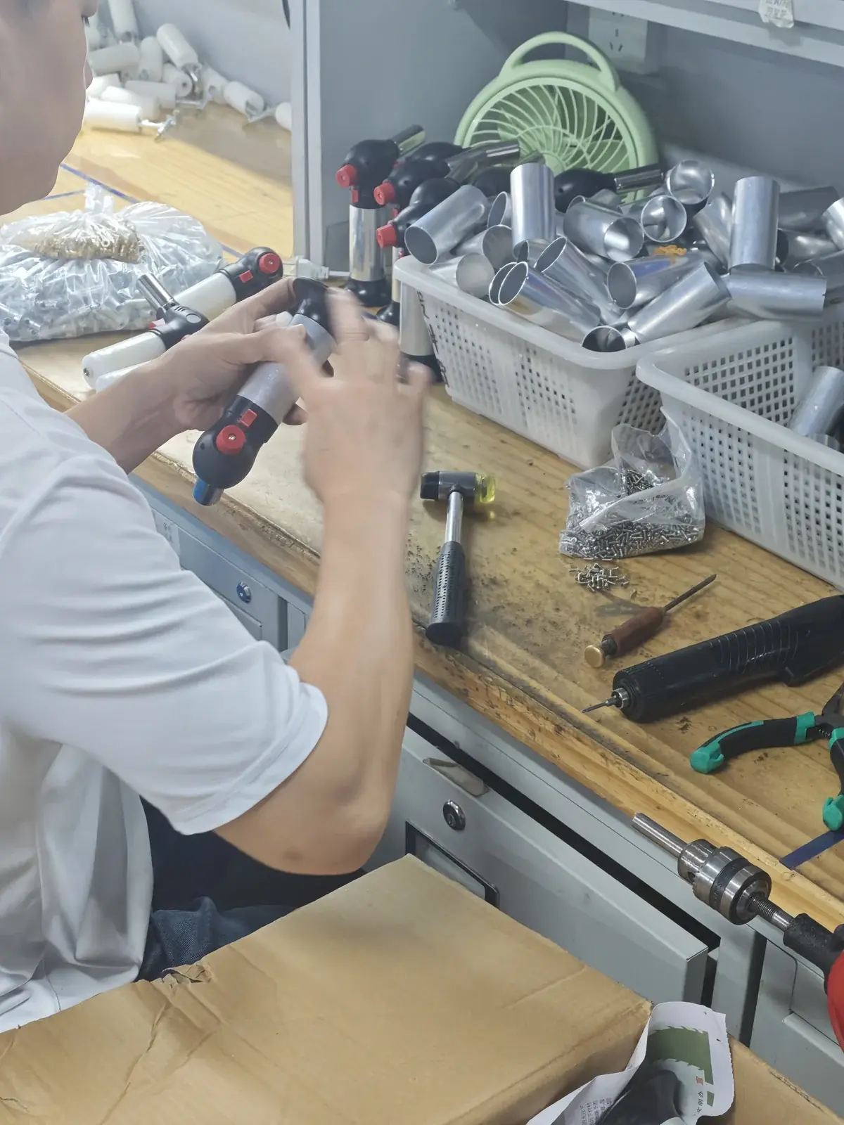 Technician assembling a refillable flame tool