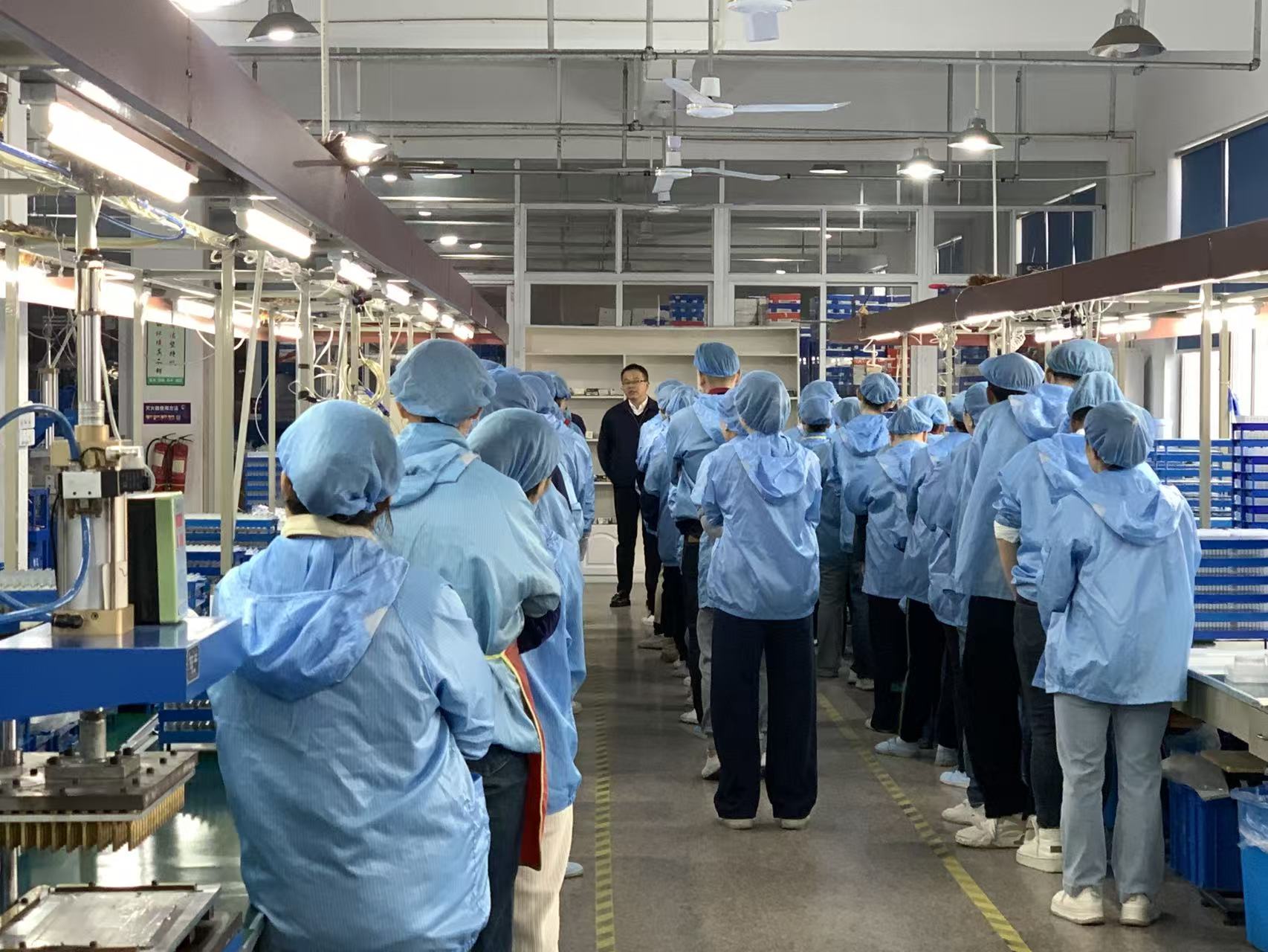 Production team briefing before work at a flame-tool assembly facility